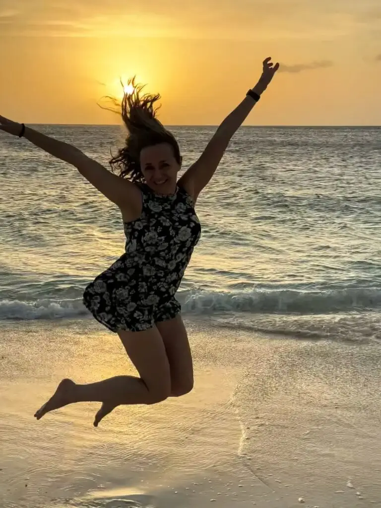 Kathy jumping for joy at the beauty of the sunset